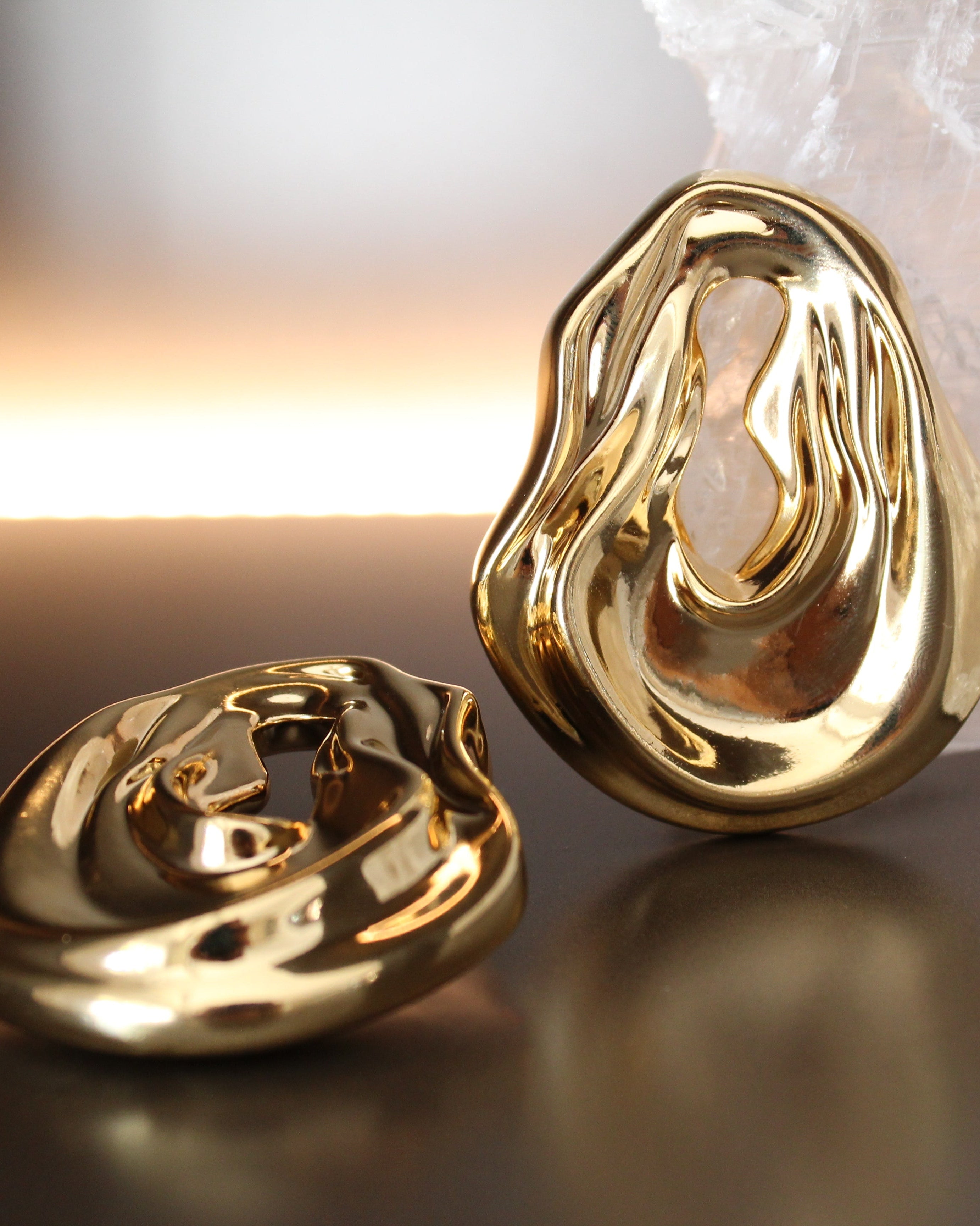 Gold plated abstract oval earrings with large sculptural asymmetric design and polished finish, 61mm by 51mm