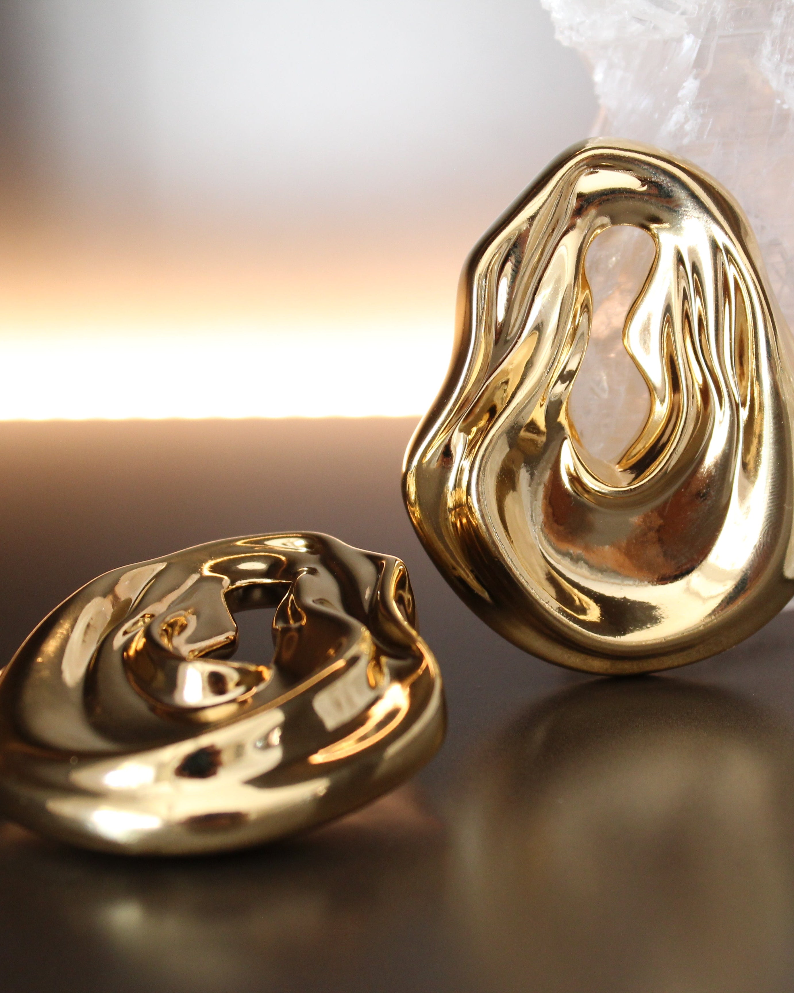 Gold plated abstract oval earrings with large sculptural asymmetric design and polished finish, 61mm by 51mm