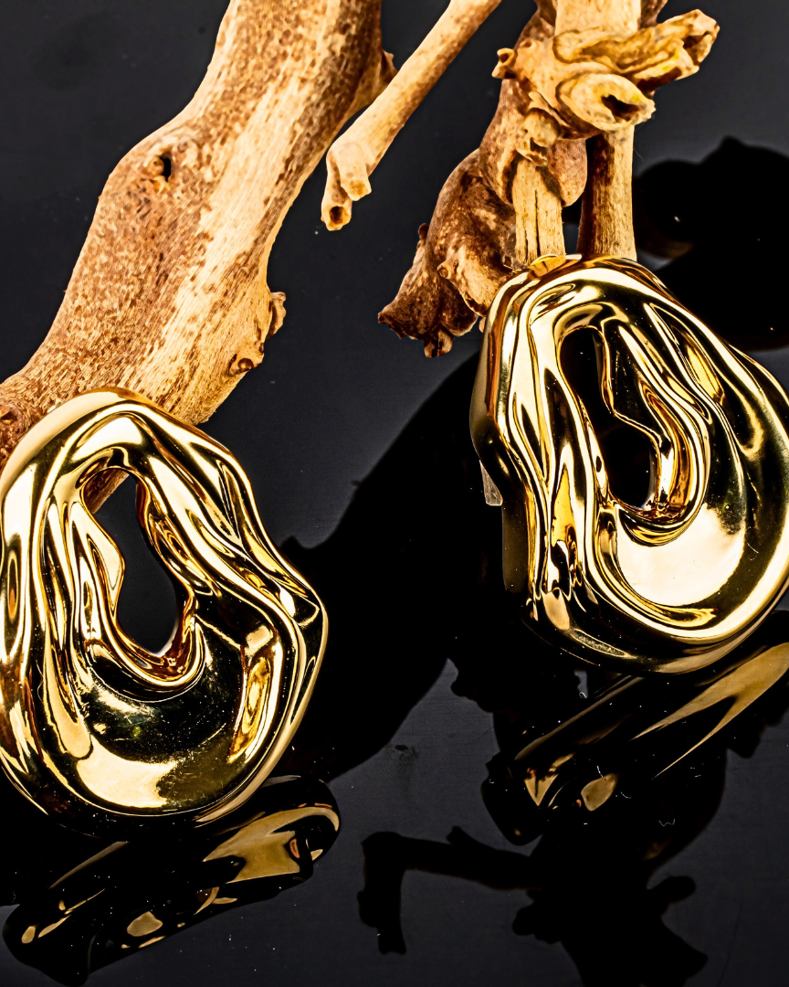 Gold plated abstract oval earrings with large sculptural asymmetric design and polished finish, 61mm by 51mm