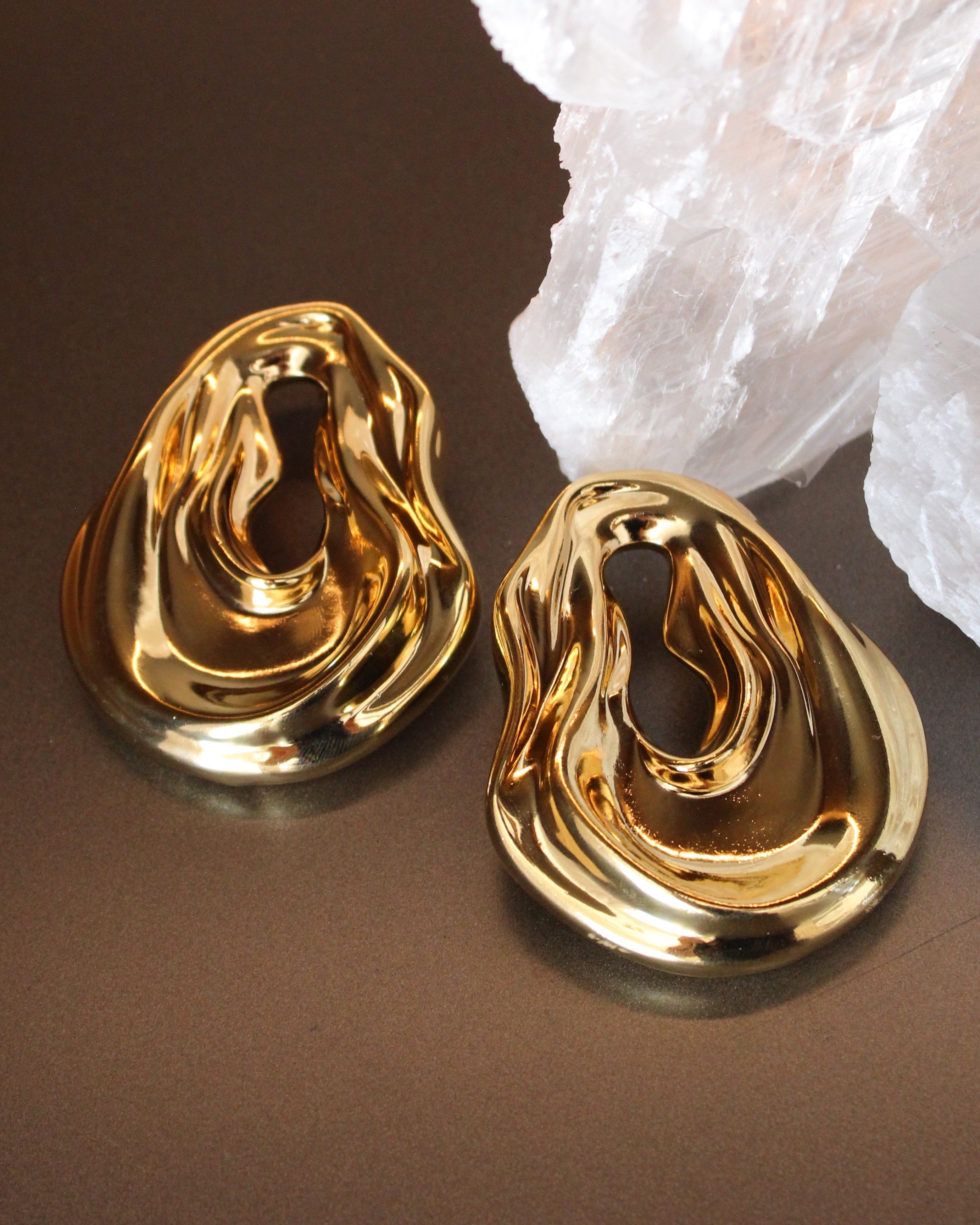 Gold plated abstract oval earrings with large sculptural asymmetric design and polished finish, 61mm by 51mm