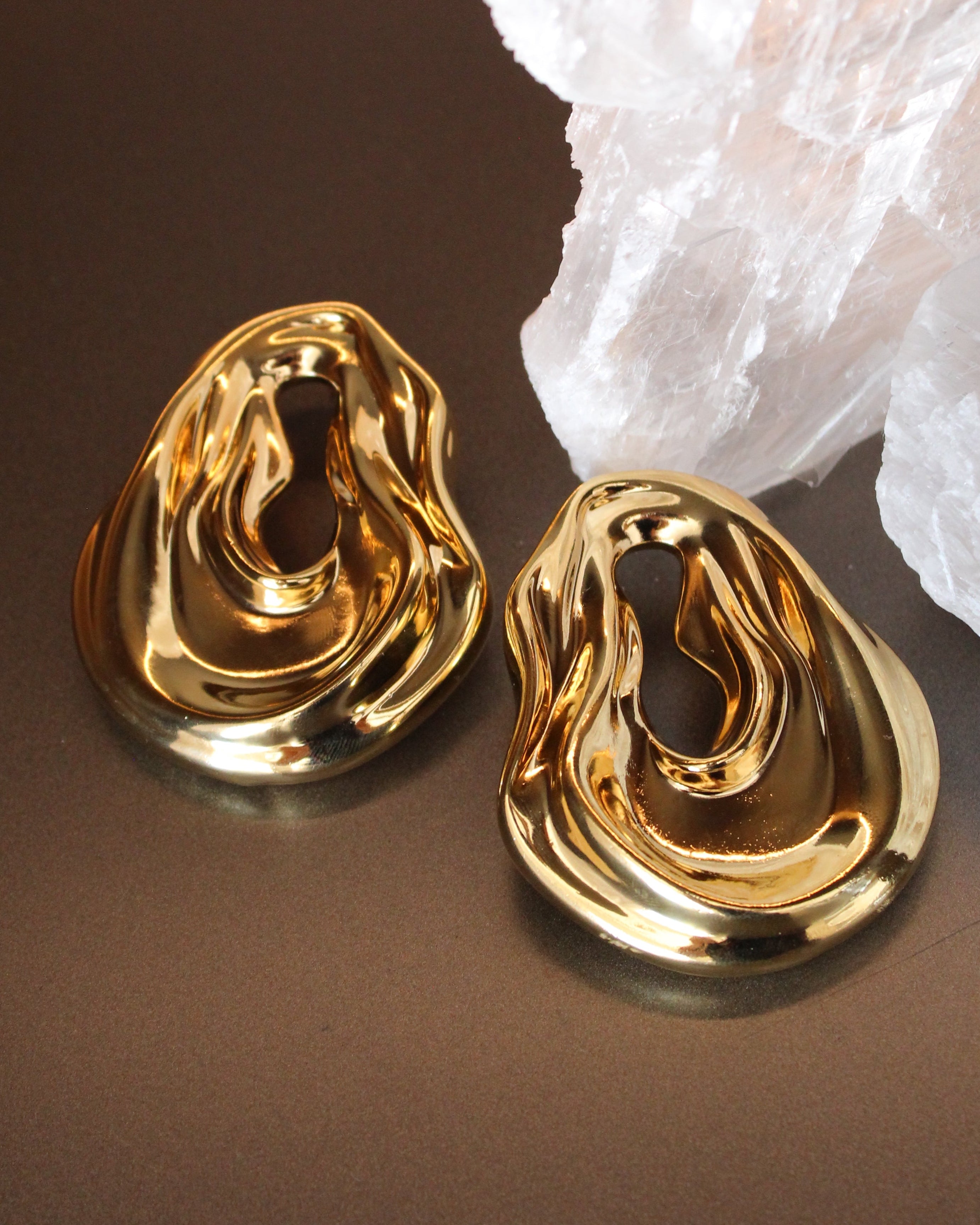 Gold plated abstract oval earrings with large sculptural asymmetric design and polished finish, 61mm by 51mm