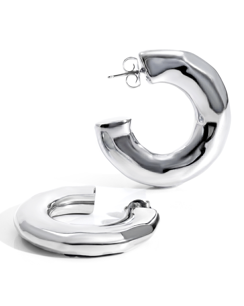 Hammered open hoop earrings available in gold plated and rhodium plated finishes with sculptural texture