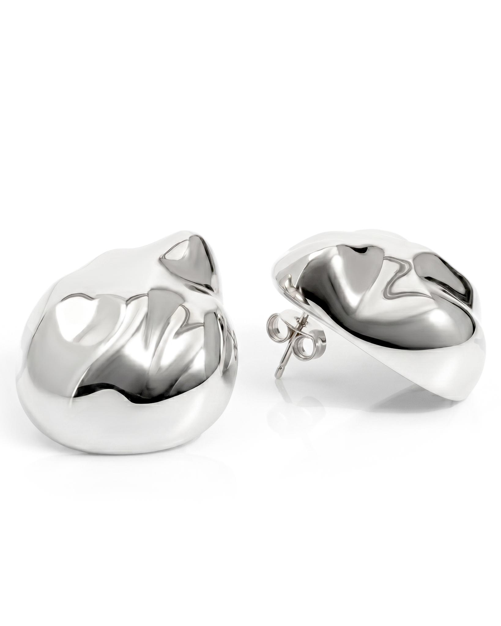 Dome earrings available in gold plated and rhodium plated finishes with dented sculptural texture