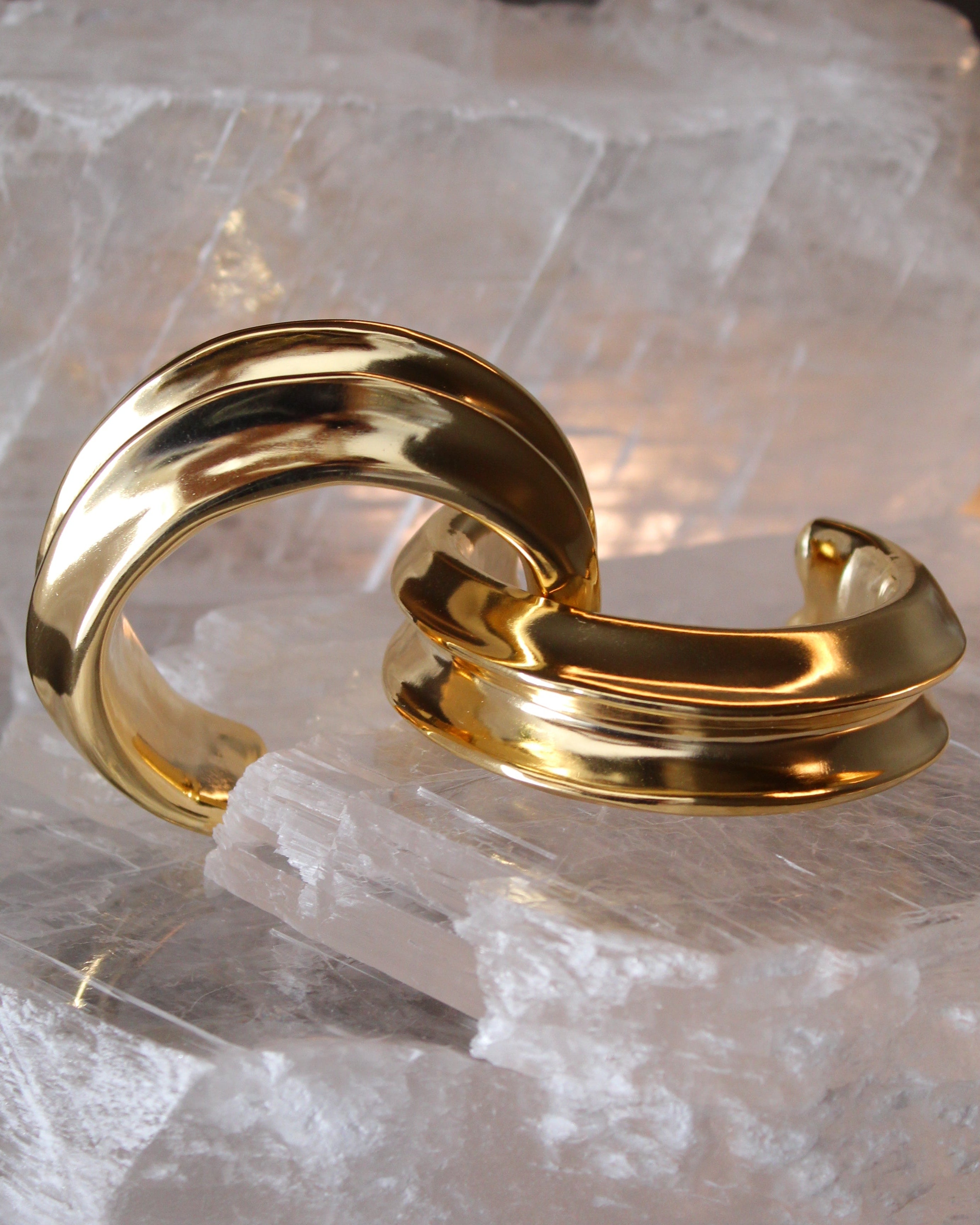 Gold plated cuff bracelet with smooth polished surface and sculptural open design, 24mm width