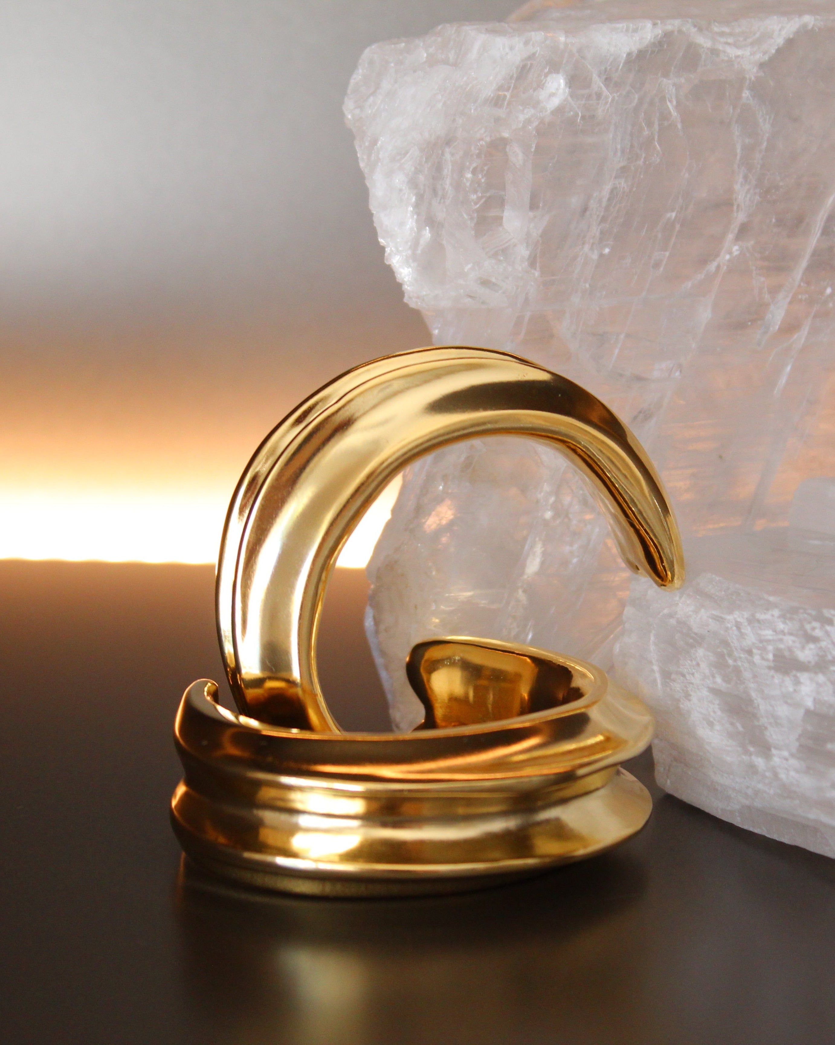 Gold plated cuff bracelet with smooth polished surface and sculptural open design, 24mm width