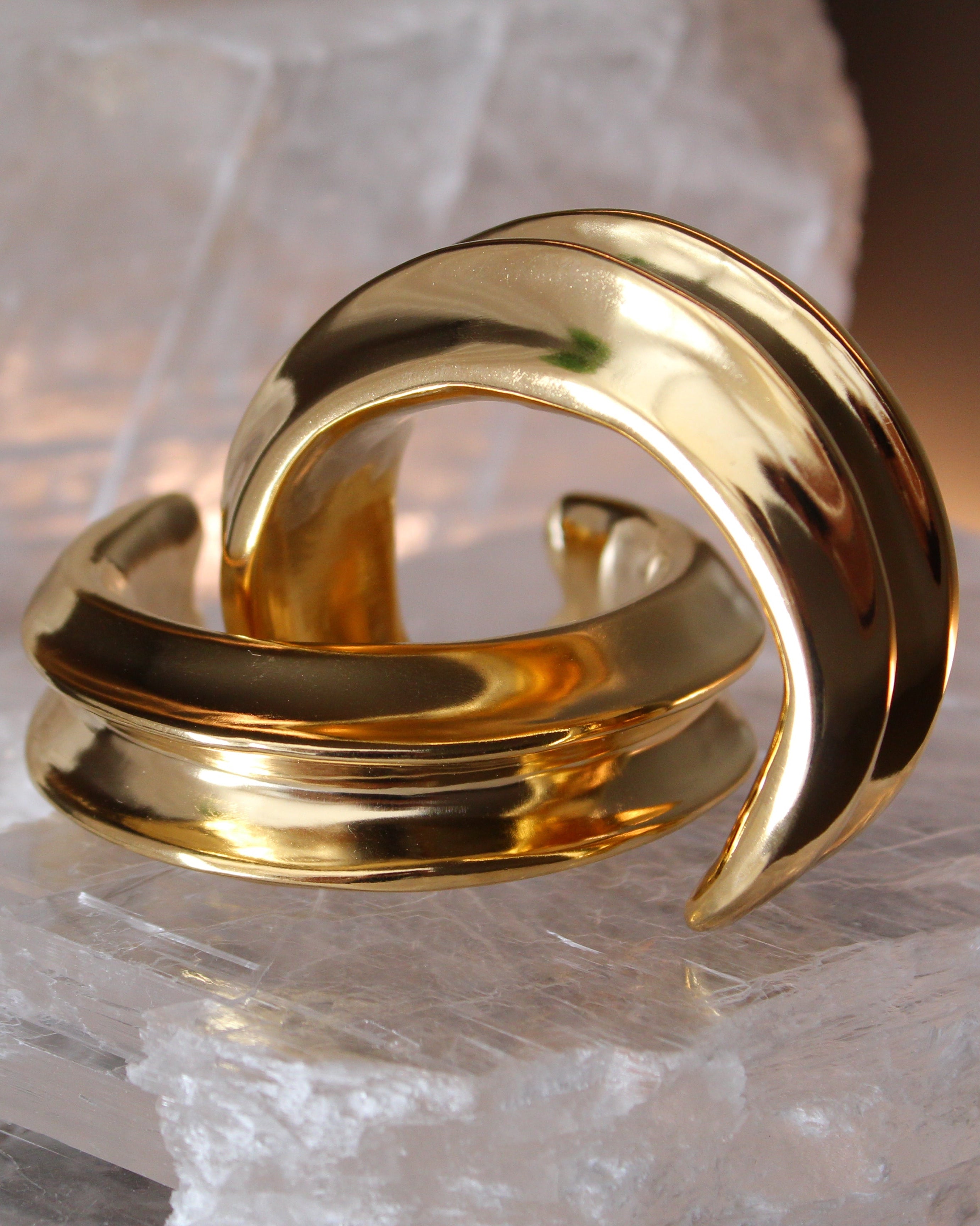 Gold plated cuff bracelet with smooth polished surface and sculptural open design, 24mm width