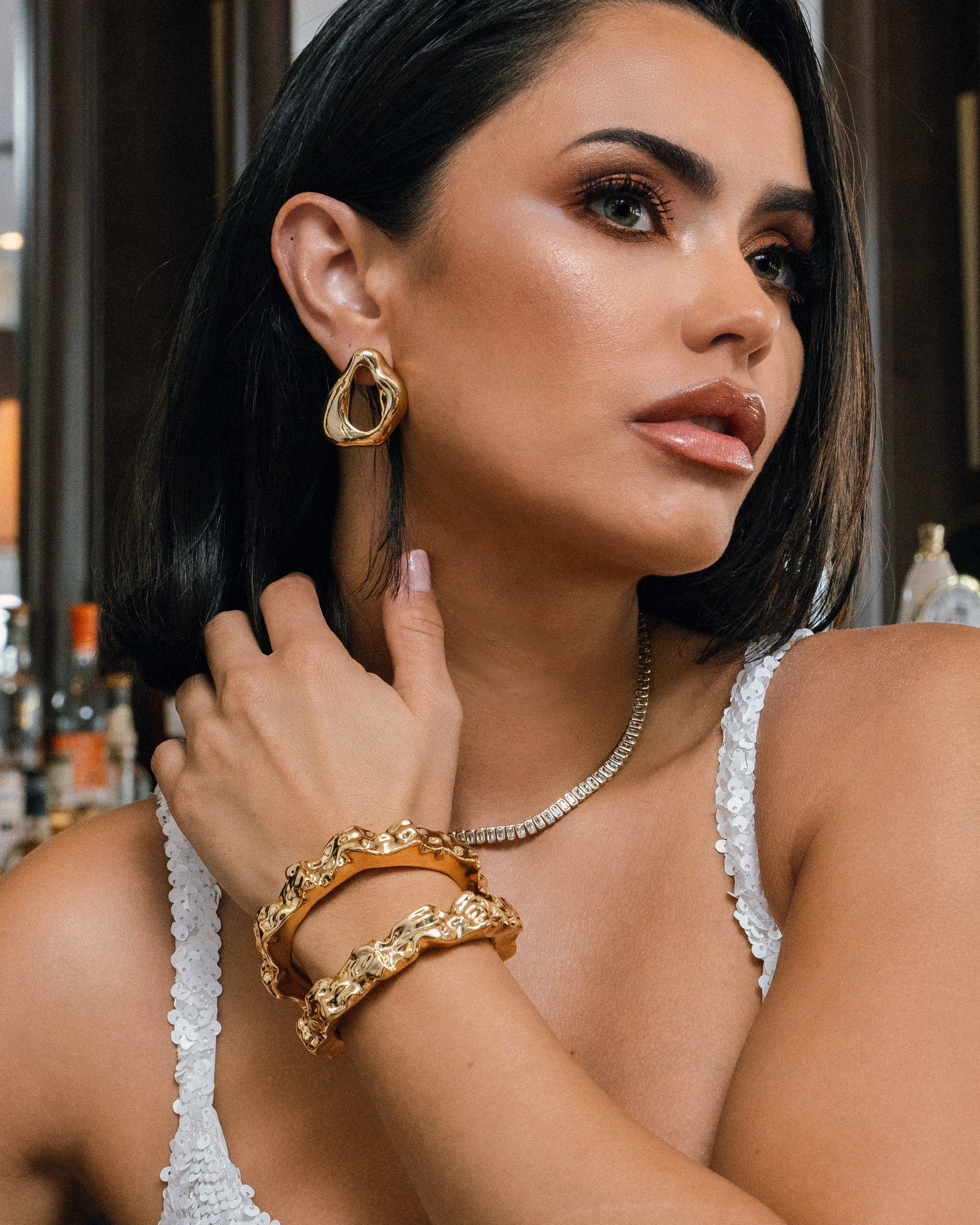 Sculpted hammered cuff bracelet available in gold plated and rhodium plated finishes with organic texture