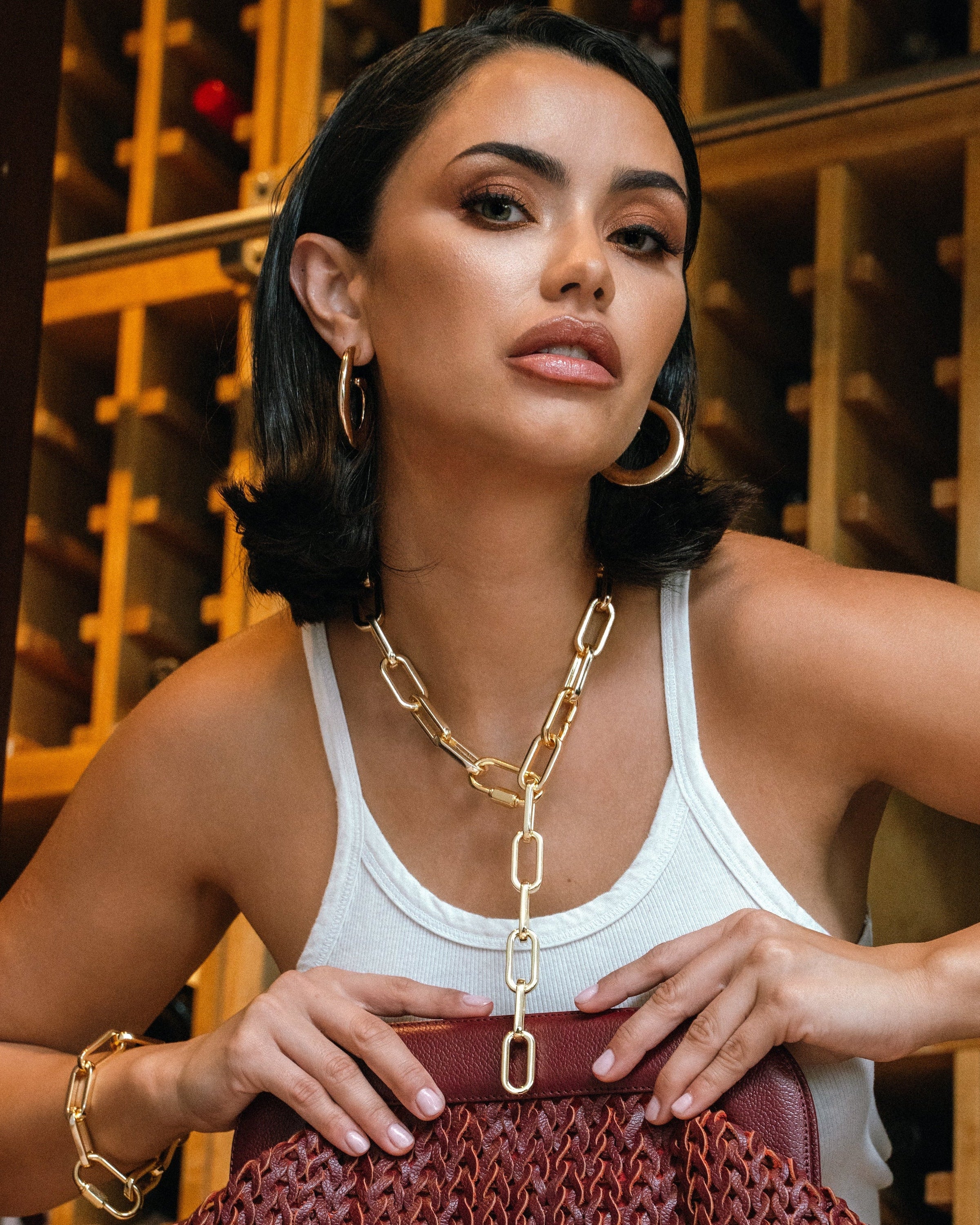 Model wearing Noemie Loop Dangle Drop Earrings Gold — 18K gold-plated earrings by Denise Pacini