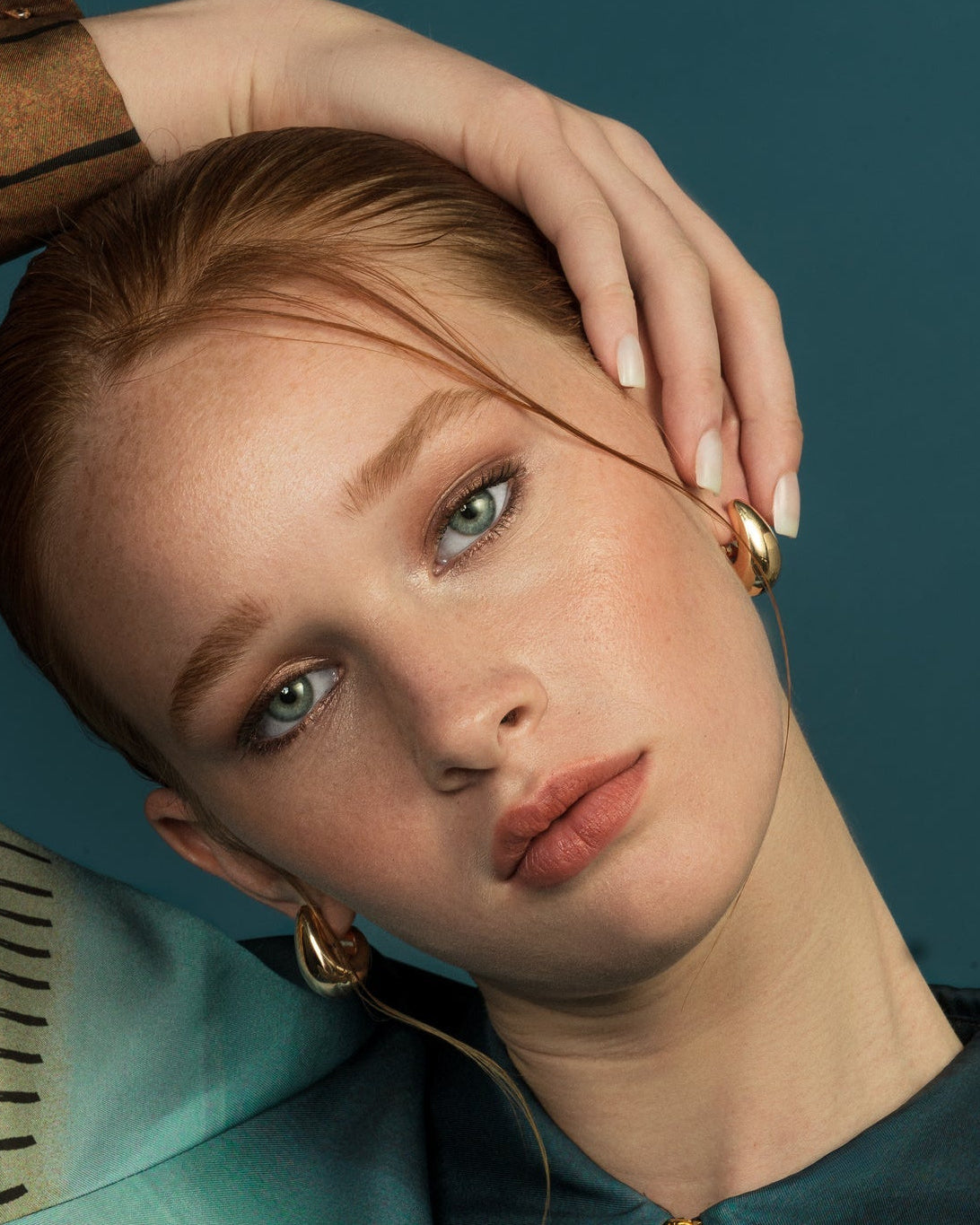Small sculptural gold and rhodium plated earrings with rounded molten-inspired design and polished high shine finish, 24mm diameter