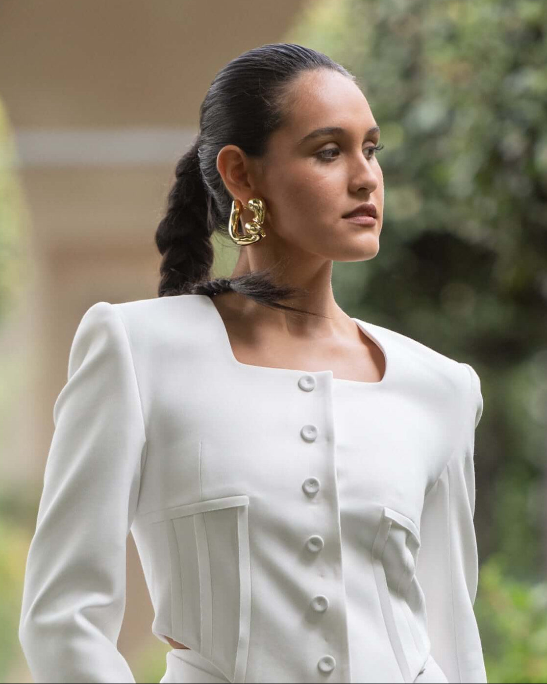 Gold plated sculptural hoop earrings with intertwined fluid design and polished finish, 57mm by 51mm