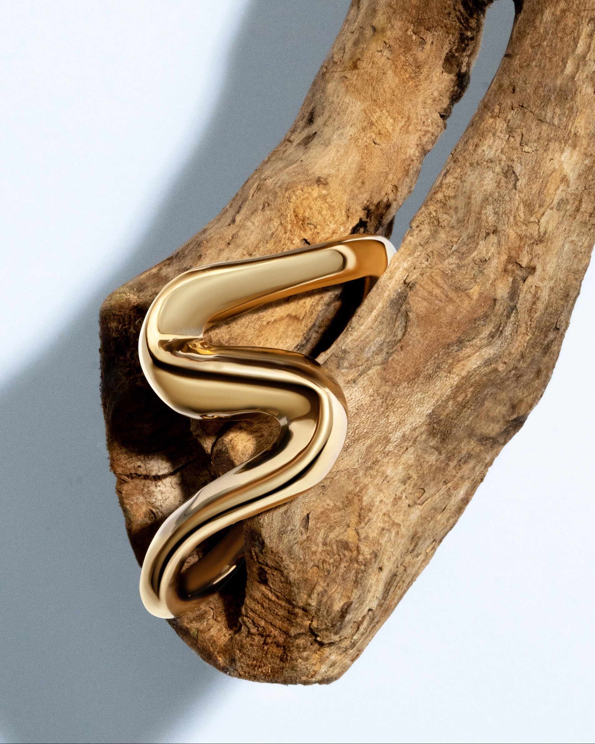 Gold sculptural cuff bracelet with S-shaped curves and 6mm thickness