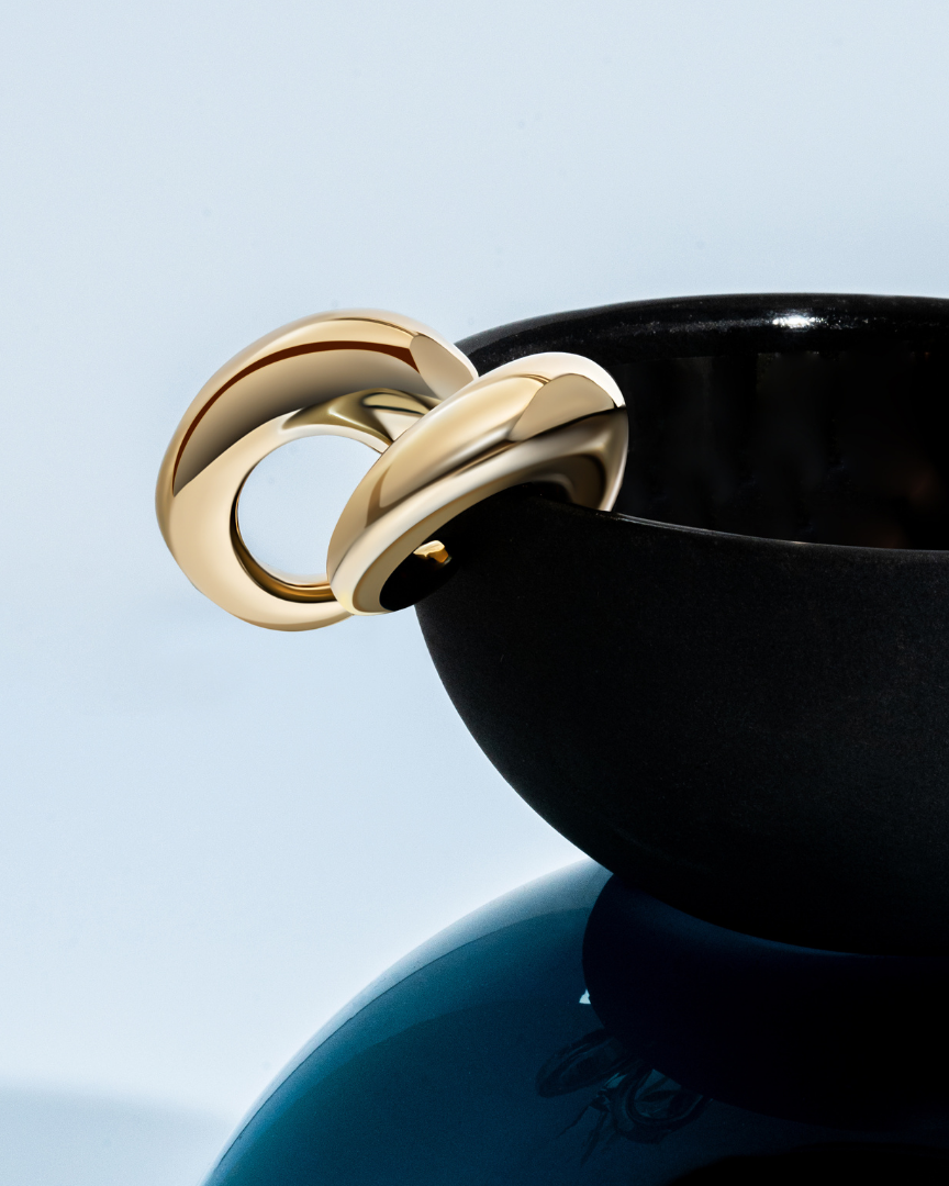 Oval open hoop earrings available in gold plated and rhodium plated finishes with sculptural thick design
