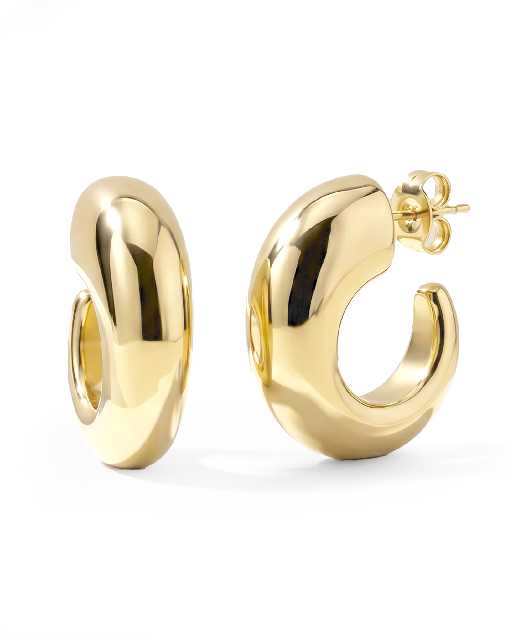 Oval open hoop earrings available in gold plated and rhodium plated finishes with sculptural thick design