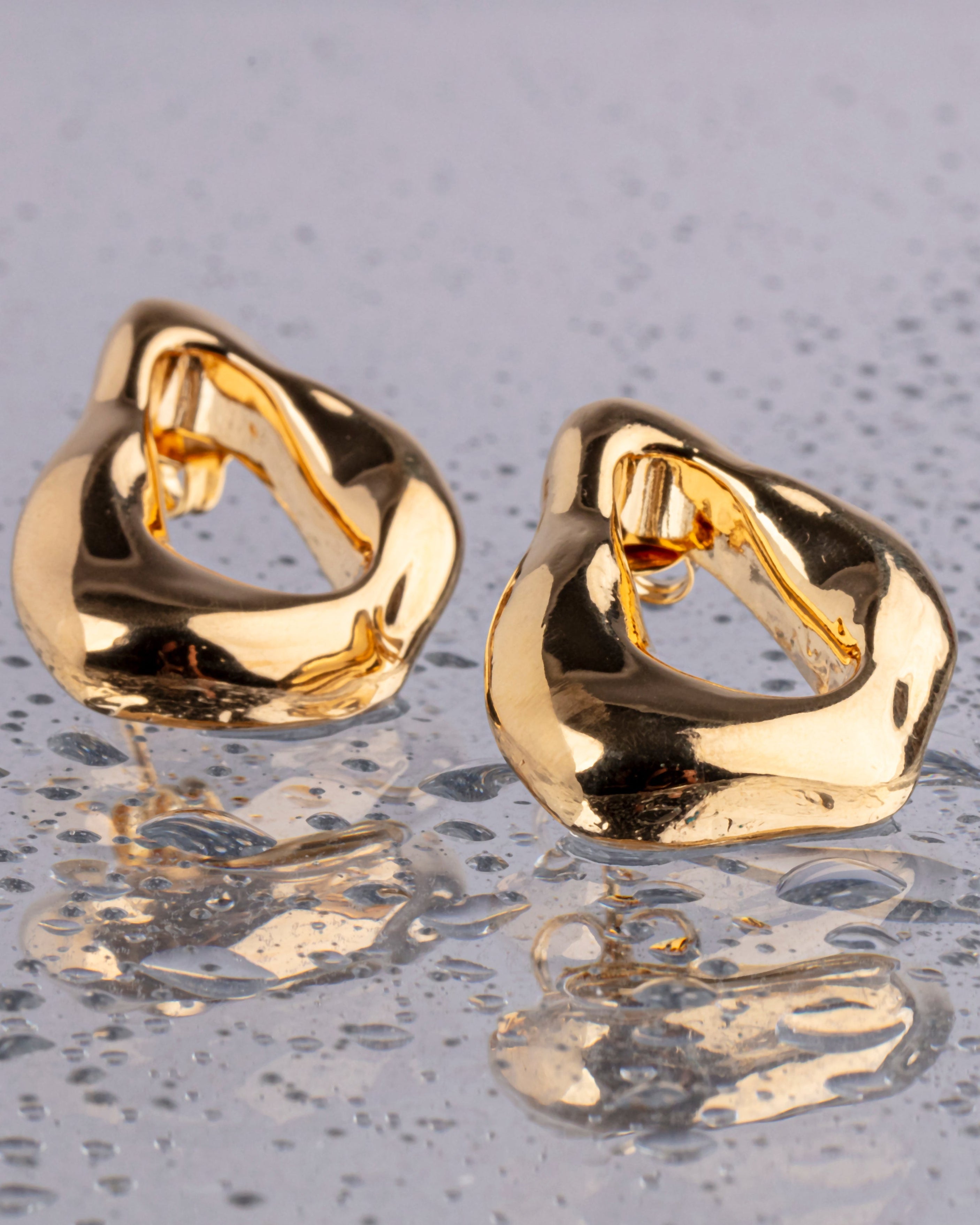 Minimal gold plated earrings with smooth polished surface and clean design