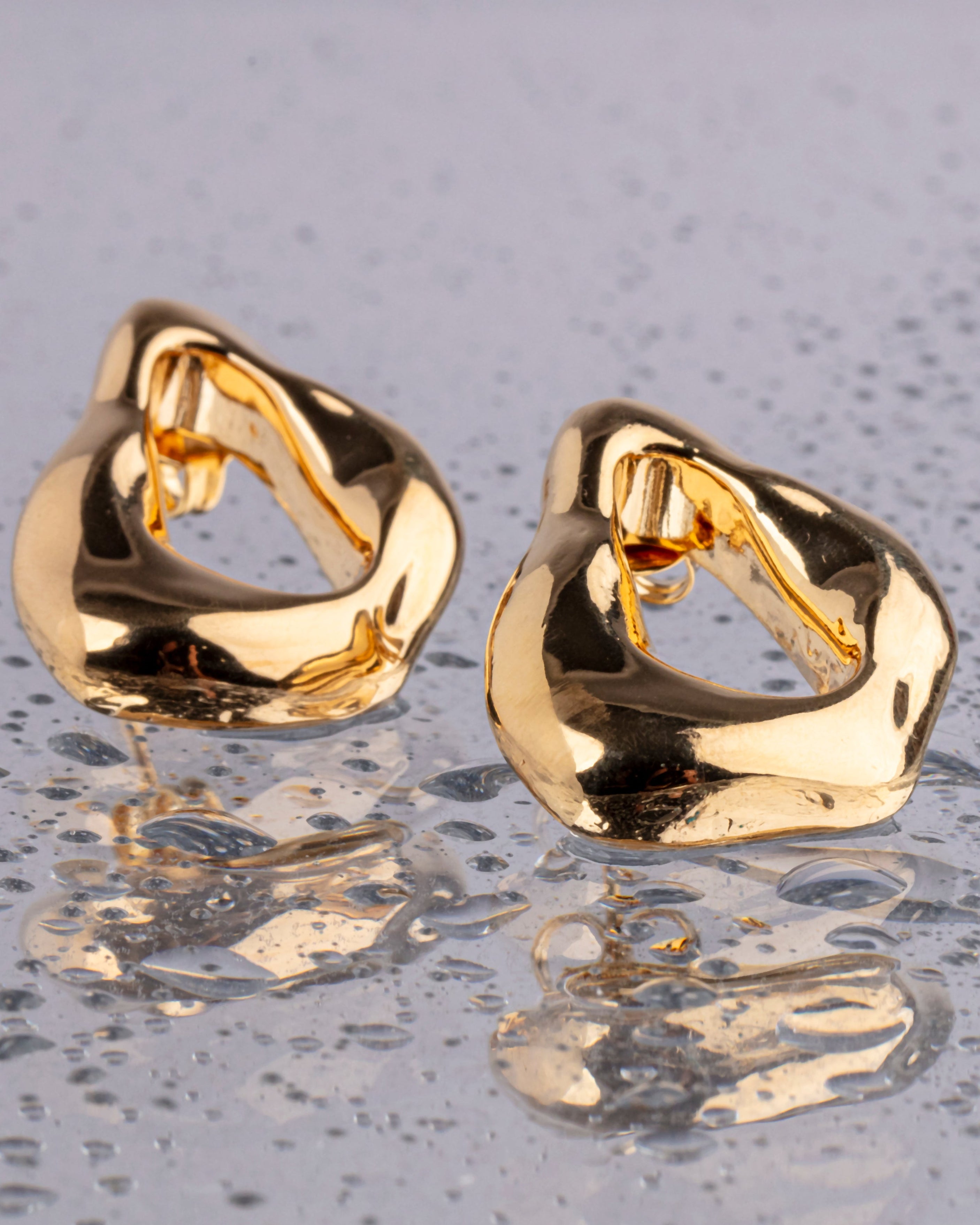 Minimal gold plated earrings with smooth polished surface and clean design