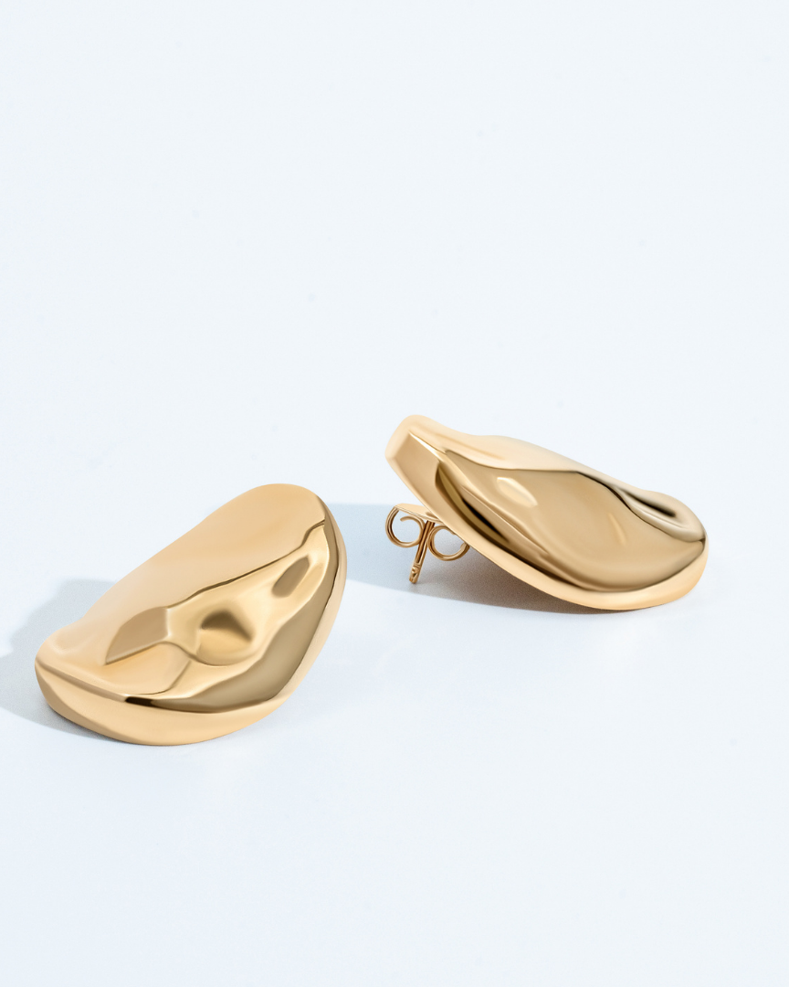 Gold oval sculptural earrings with smooth curved design and polished finish