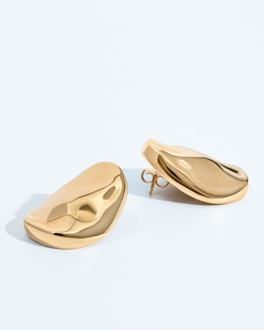 Gold oval sculptural earrings with smooth curved design and polished finish