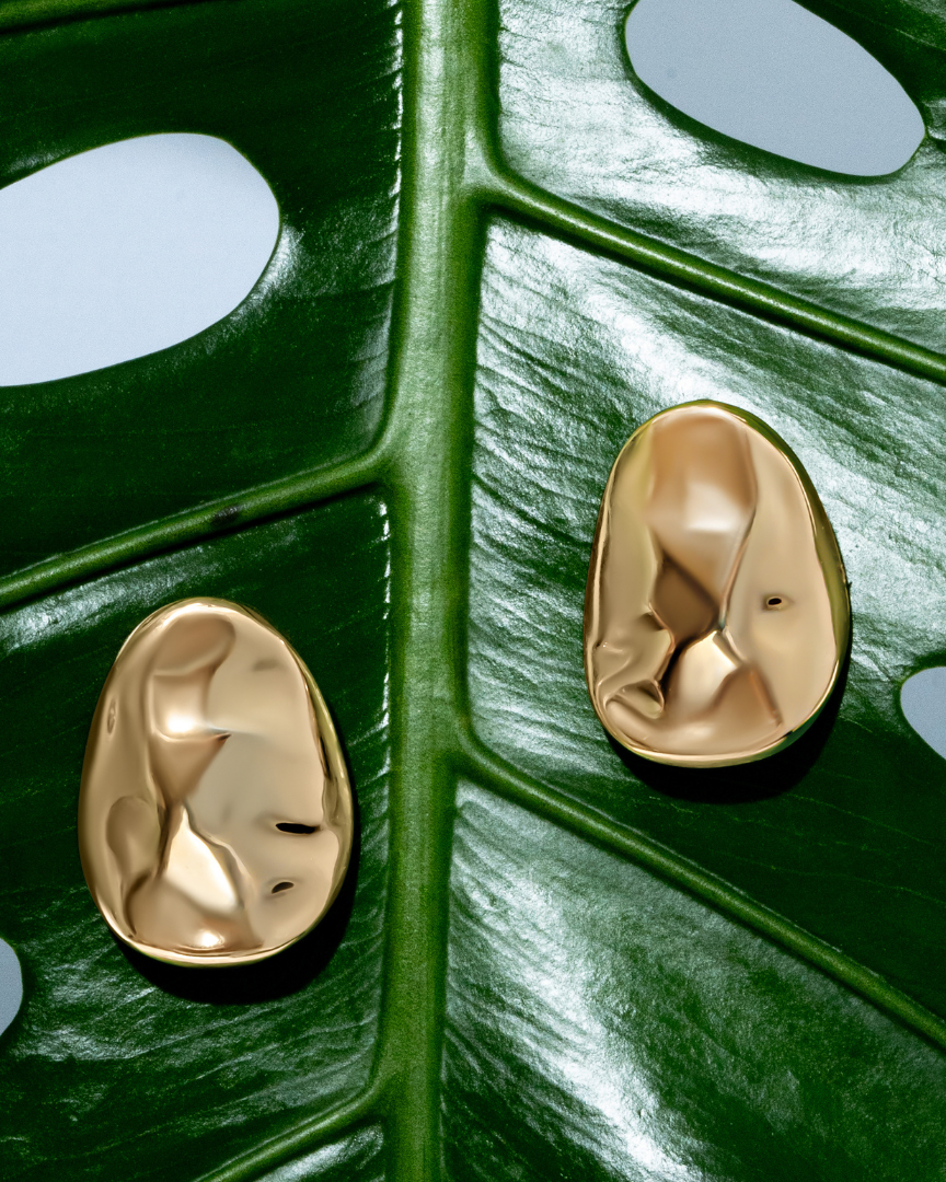 Gold oval sculptural earrings with smooth curved design and polished finish