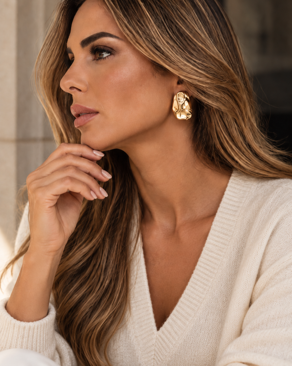 a model wearing a Sculptural teardrop gold earrings