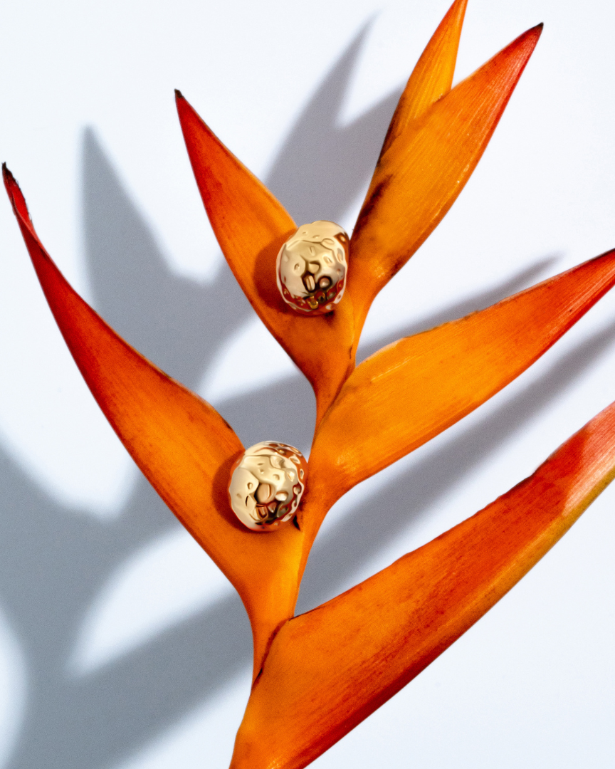 Gold sculptural earrings with compact organic texture and polished finish