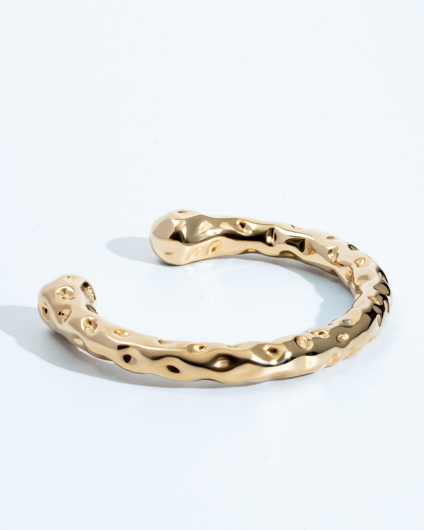 Gold molten textured cuff bracelet with organic sculptural design and 8mm thickness