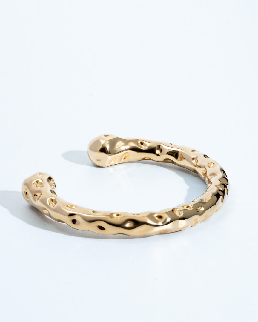 Gold molten textured cuff bracelet with organic sculptural design and 8mm thickness