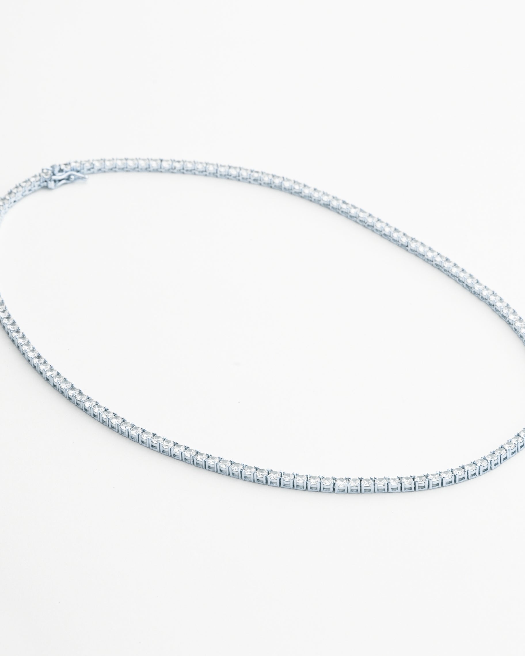 Tennis necklace and bracelet set with cubic zirconia stones available in gold plated and rhodium finishes