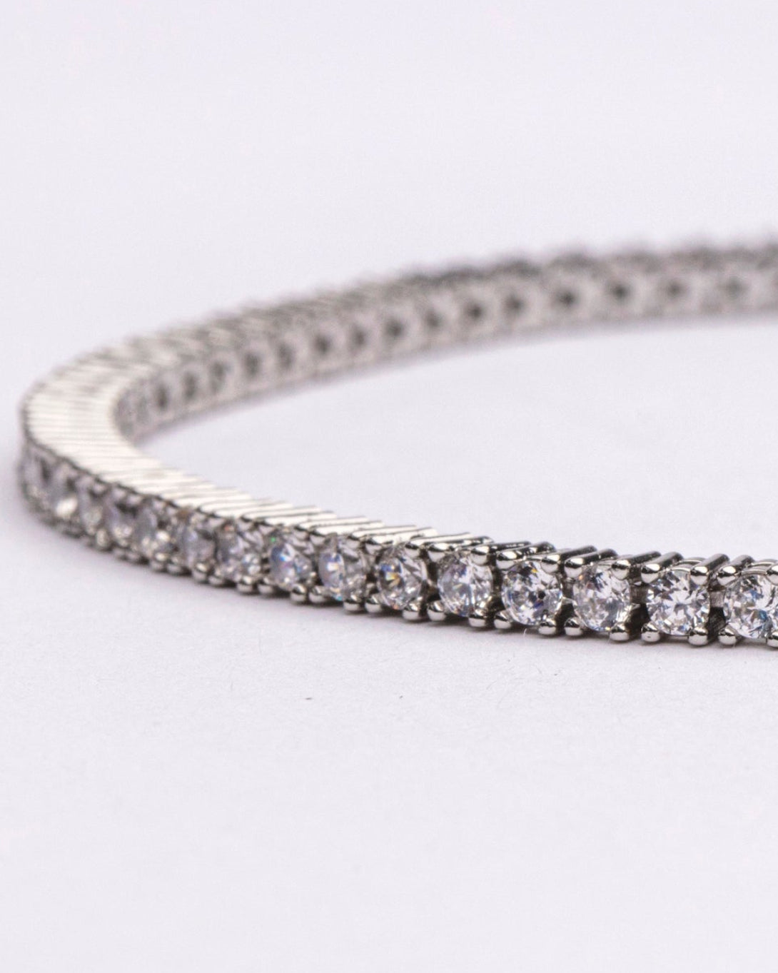Tennis necklace and bracelet set with cubic zirconia stones available in gold plated and rhodium finishes