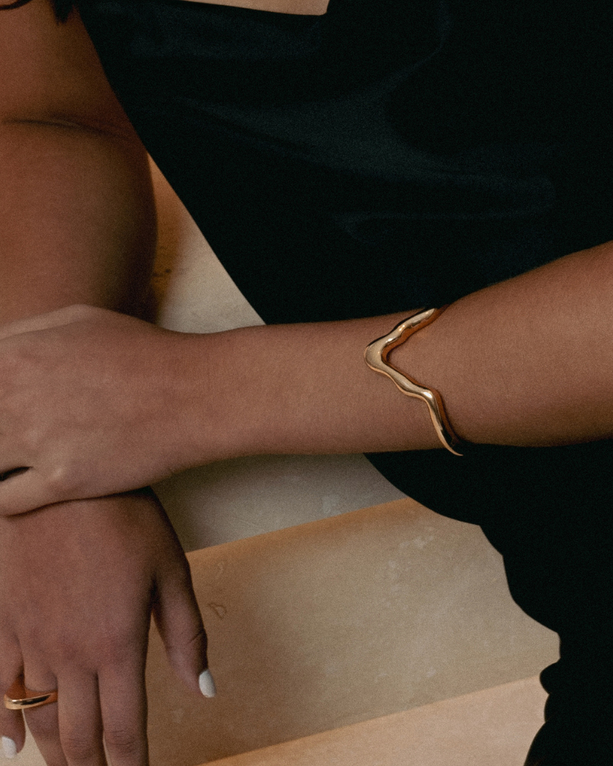 Gold sculptural bracelet with organic curved design and polished finish