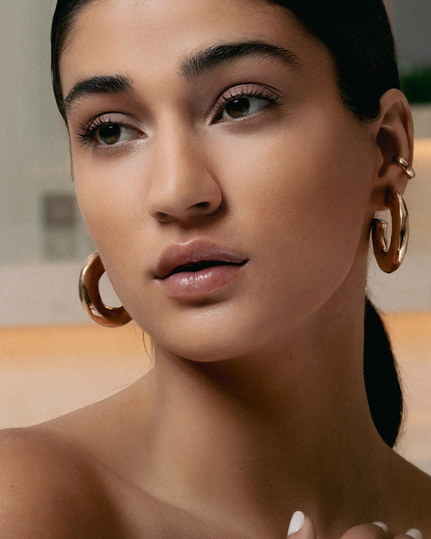 Hammered open hoop earrings available in gold plated and rhodium plated finishes with sculptural texture