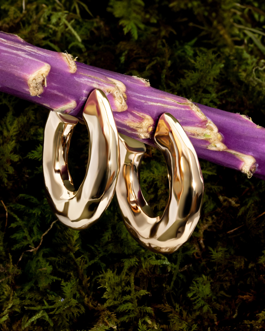 Hammered open hoop earrings available in gold plated and rhodium plated finishes with sculptural texture