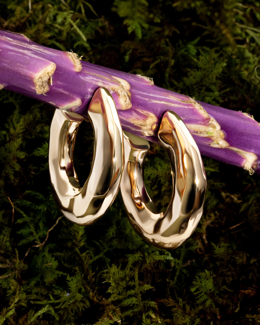 Hammered open hoop earrings available in gold plated and rhodium plated finishes with sculptural texture