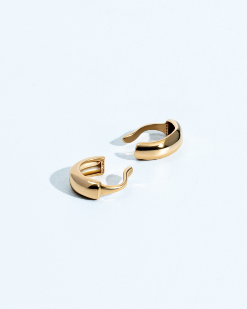 Gold thin ear cuff with minimal curved design and polished finish