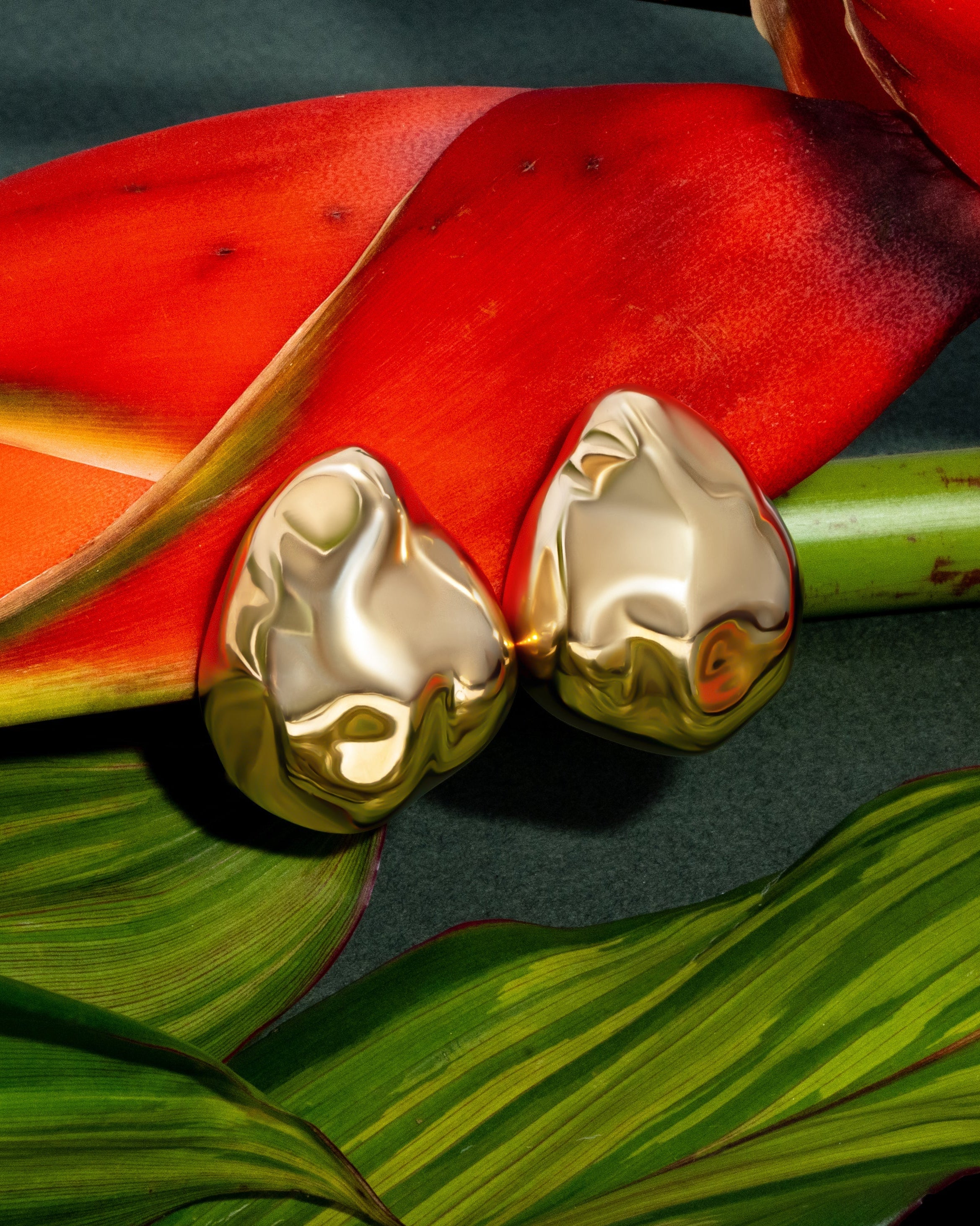 Dome earrings available in gold plated and rhodium plated finishes with dented sculptural texture