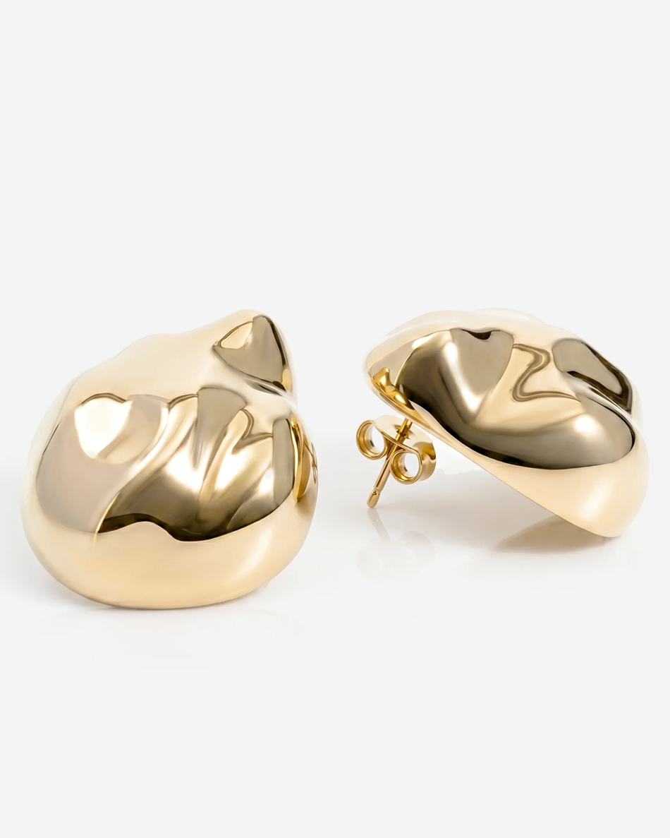 Dome earrings available in gold plated and rhodium plated finishes with dented sculptural texture