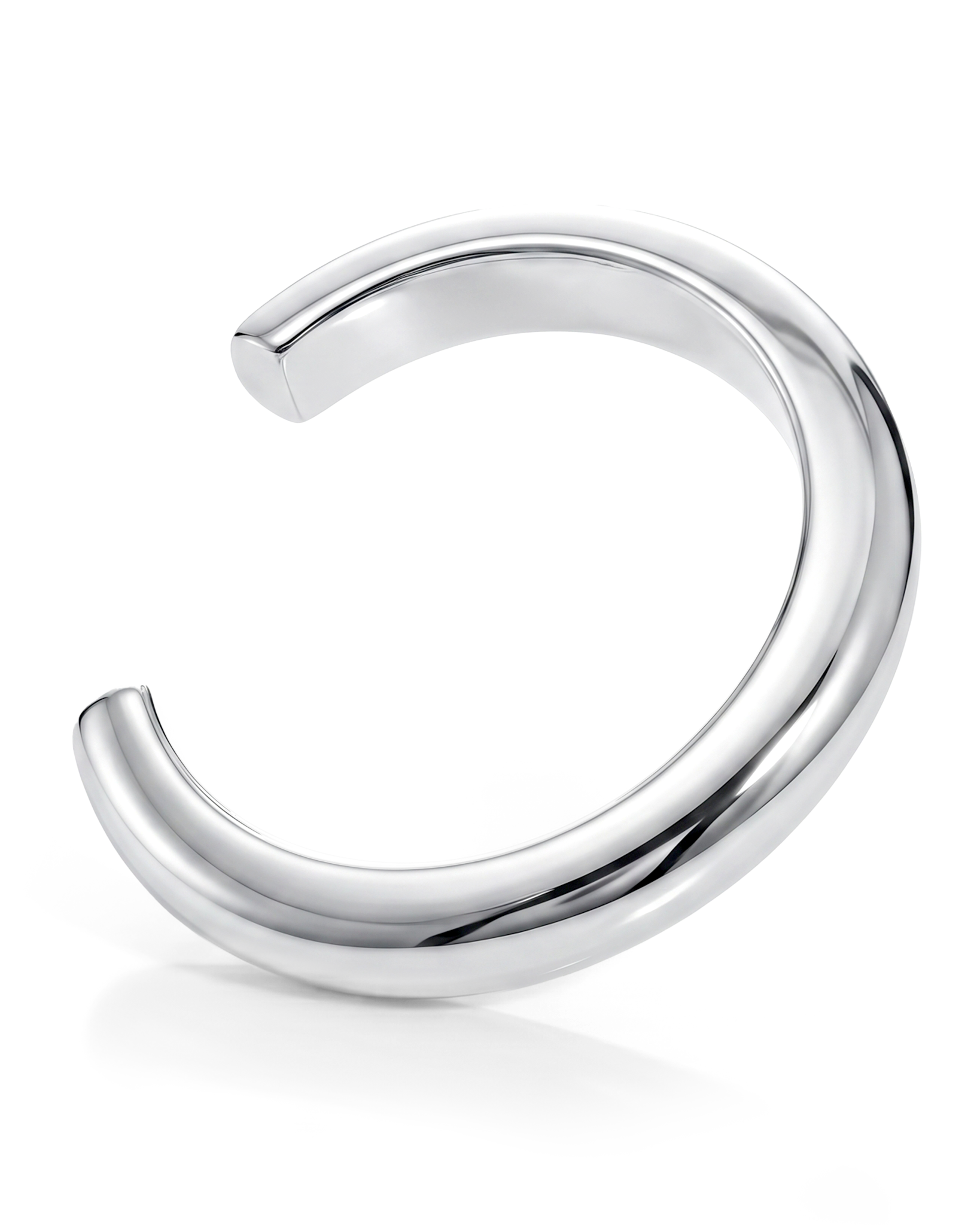 Sculptural cuff bracelet available in gold plated and rhodium plated finishes with bold circular design