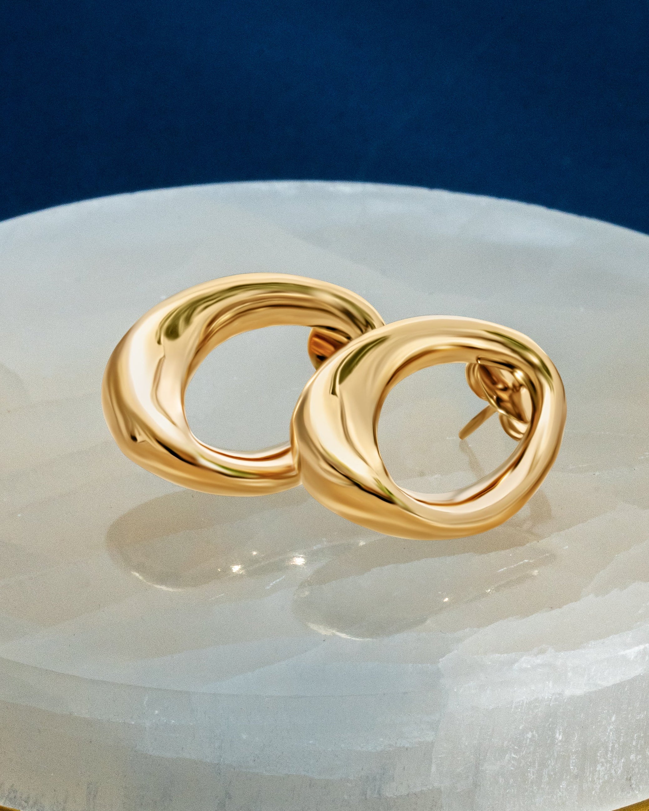 Abstract oval earrings available in gold plated and rhodium plated finishes with sculptural geometric design