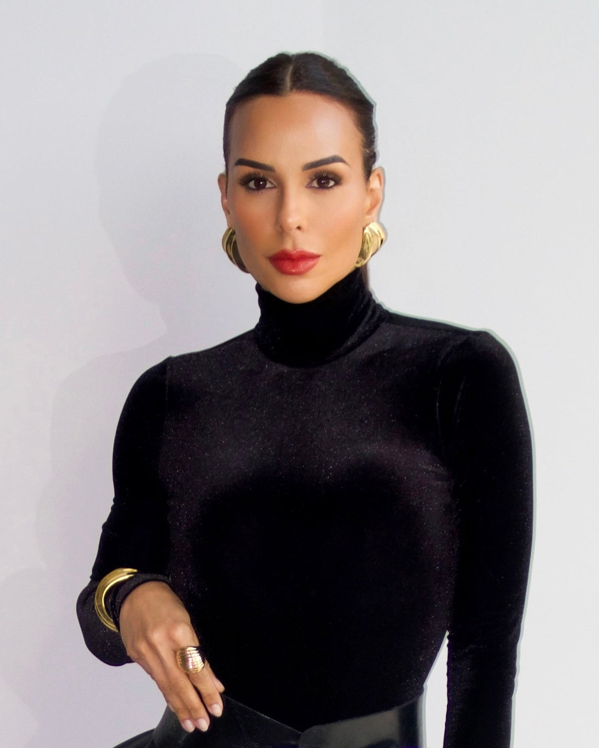 a model wearing a Triple wave gold statement earrings