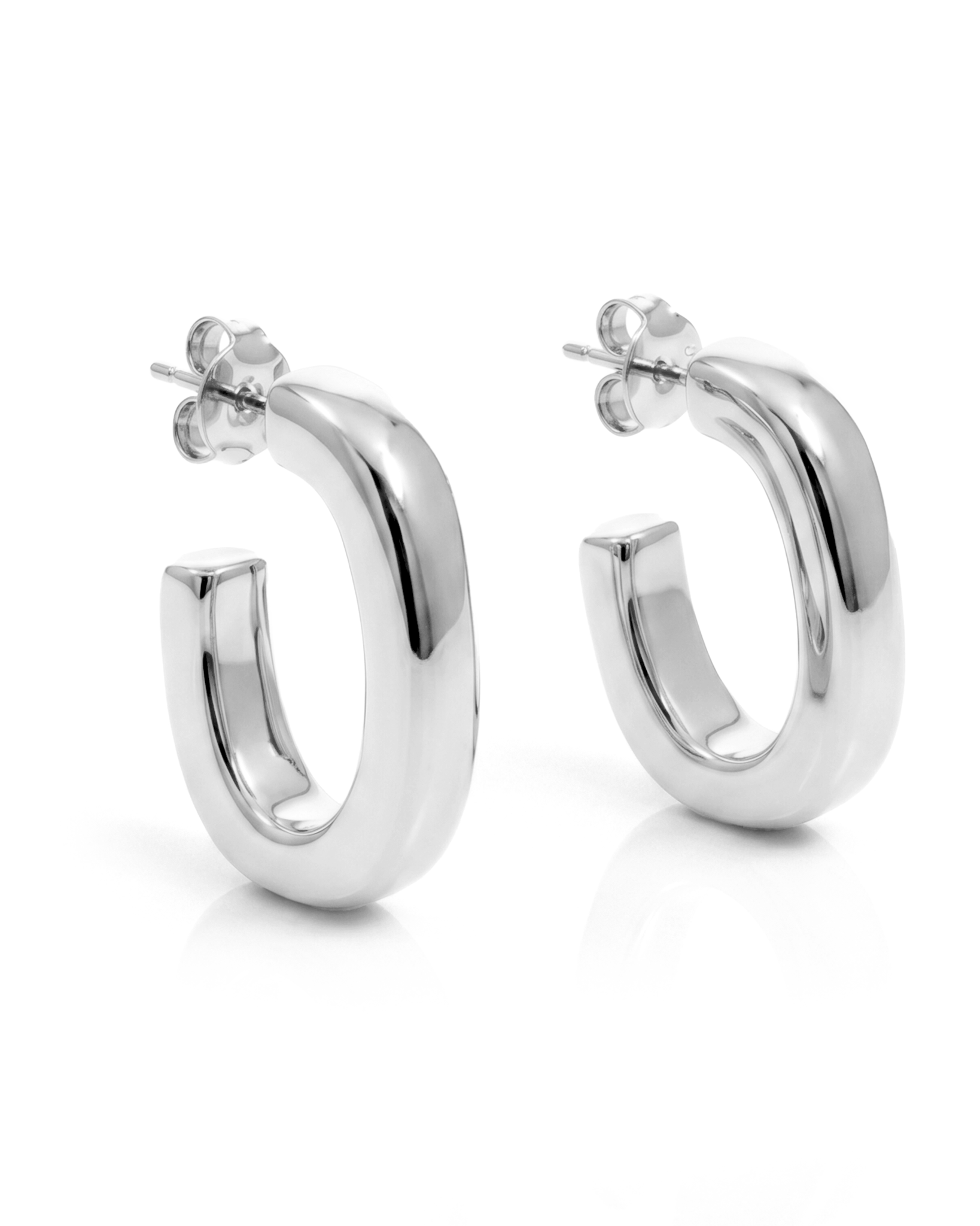 Oval open hoop earrings available in gold plated and rhodium plated finishes with sculptural curved design