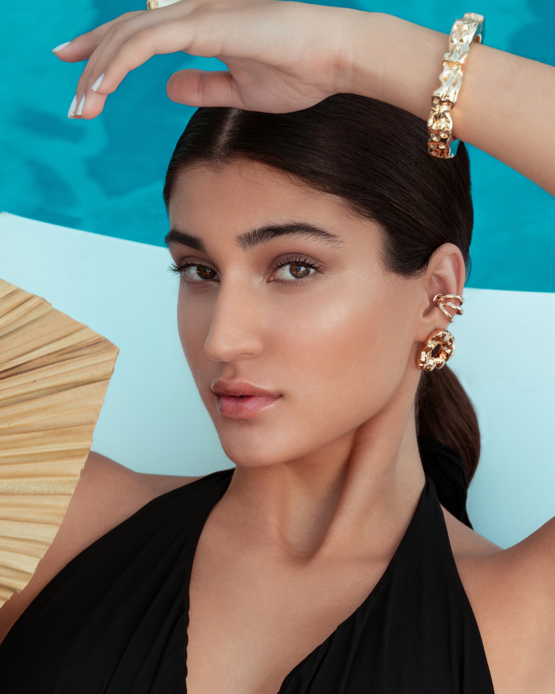 Triple strand ear cuff available in gold plated and rhodium plated finishes with sculptural layered design