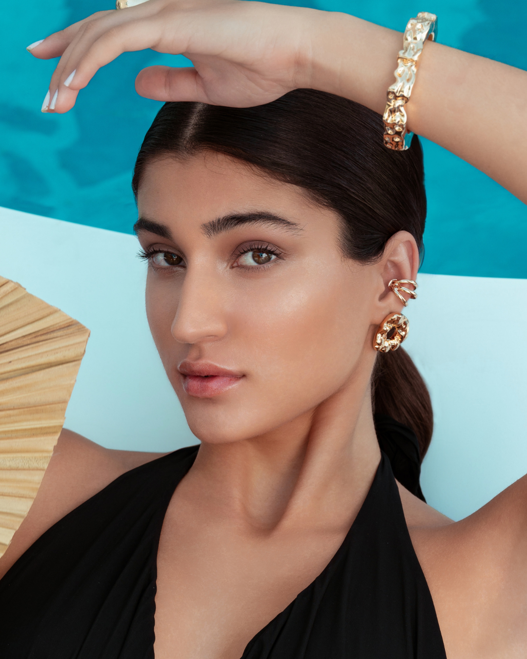 Triple strand ear cuff available in gold plated and rhodium plated finishes with sculptural layered design