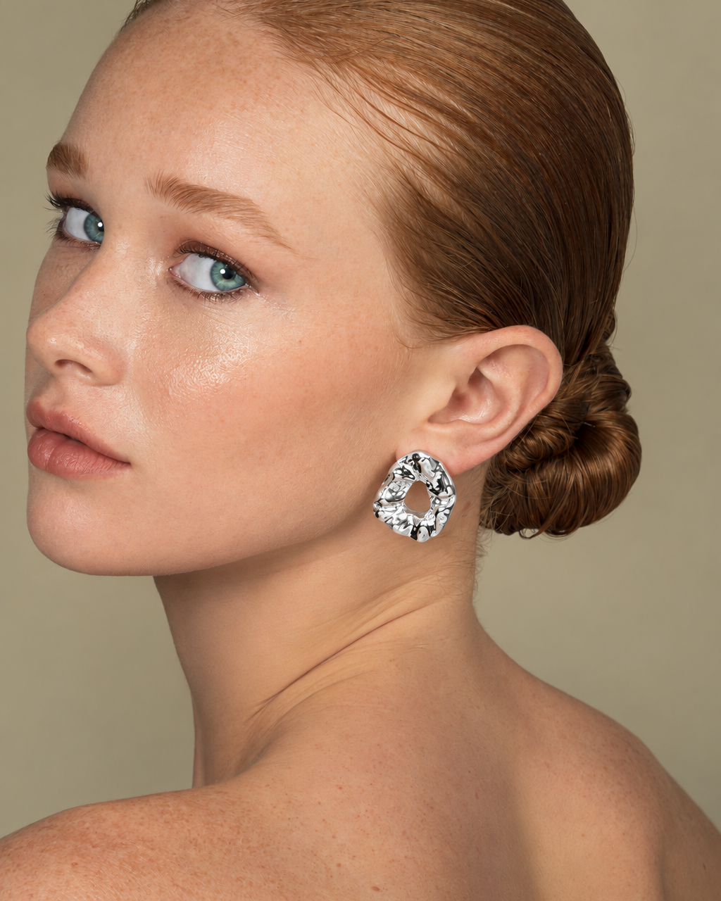 a model wearing a Hammered organic silver statement earrings
