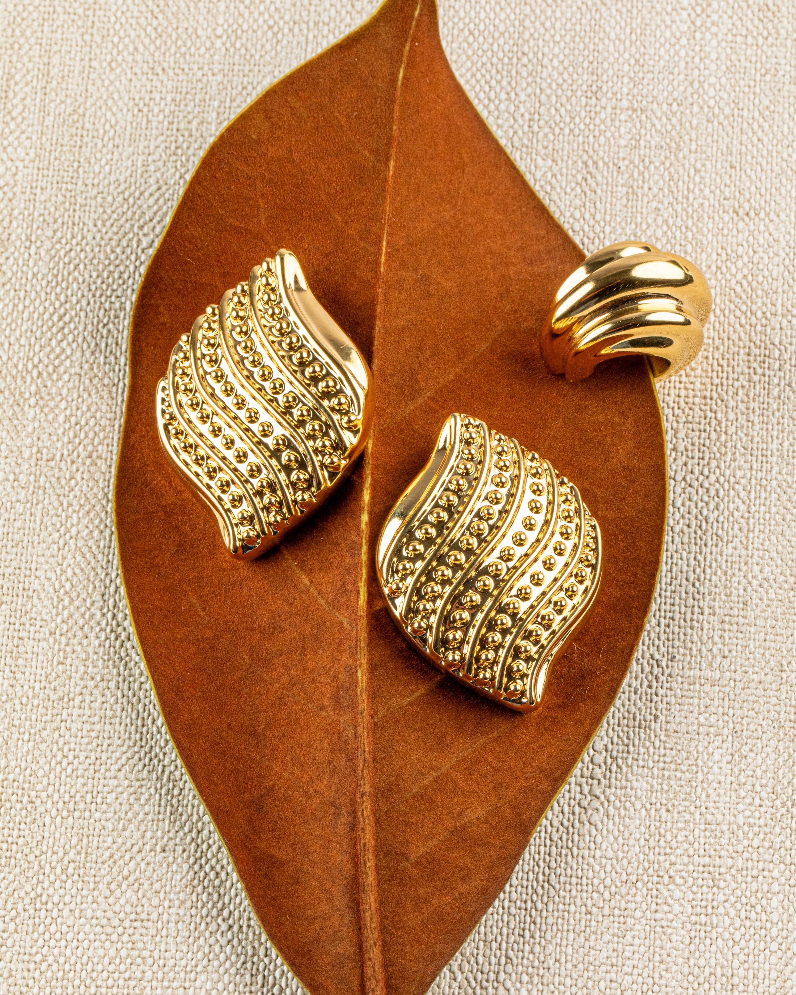 Gold plated layered ear cuff with stacked bands and thick structured design, no piercing required