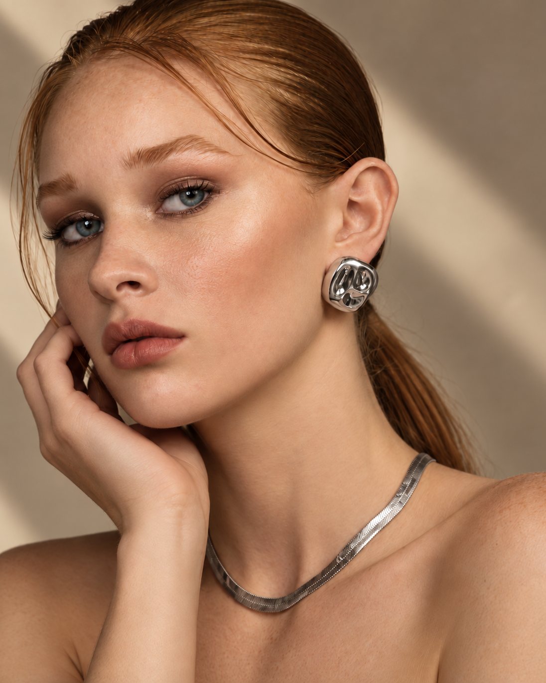 a model wearing a Organic square silver statement earrings