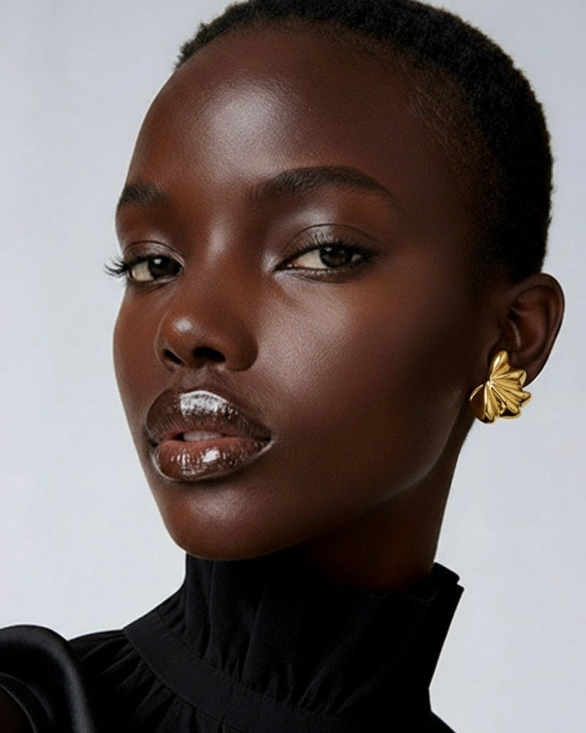 Gold plated fan-shaped sculptural earrings with layered radiating design and polished finish