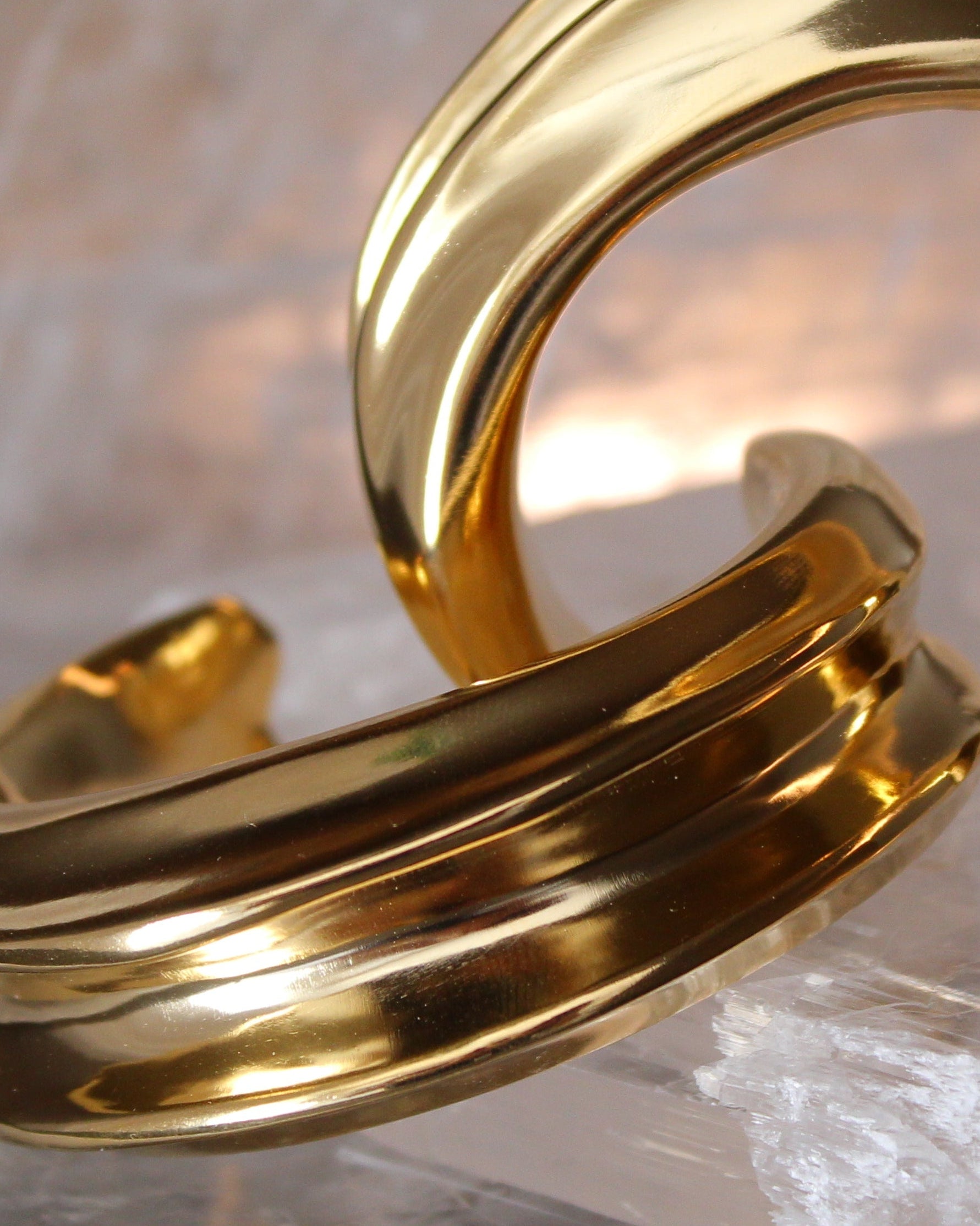 Gold plated cuff bracelet with smooth polished surface and sculptural open design, 24mm width
