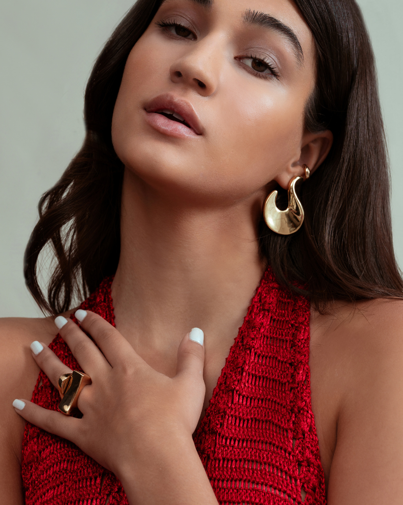 Abstract hook earrings available in gold plated and rhodium plated finishes with sculptural curved design