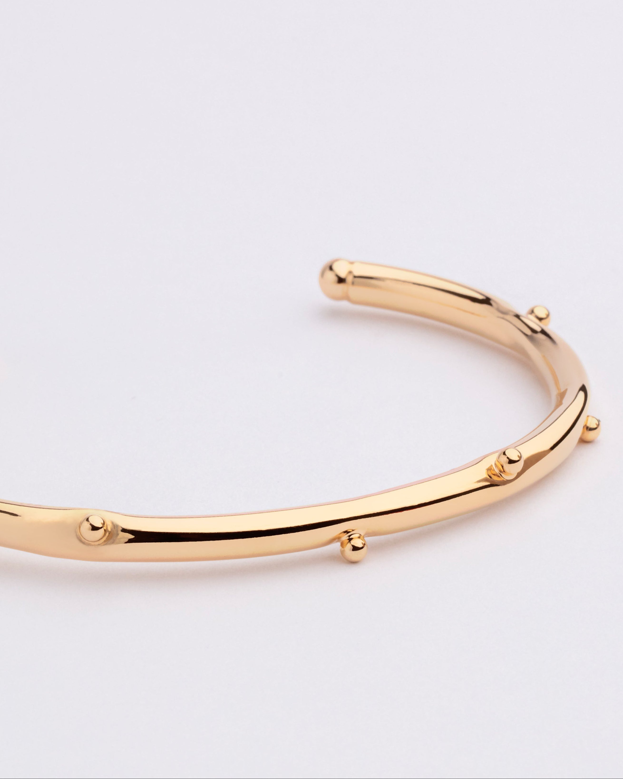 Gold plated bracelet with clean structured design and polished finish