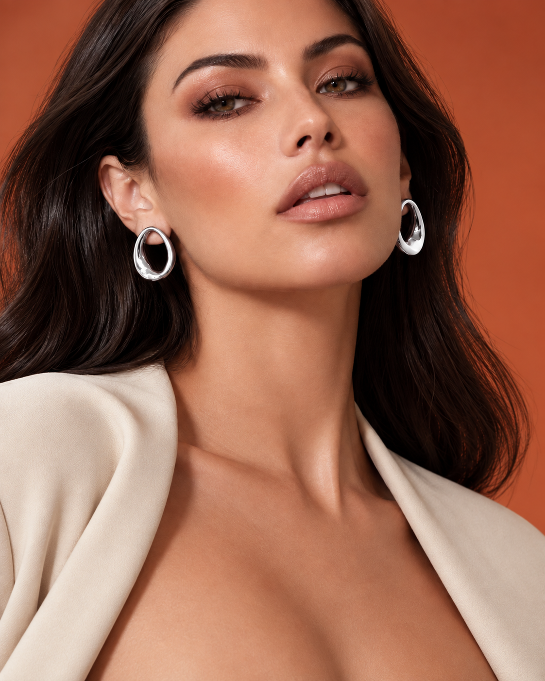 a model wearing an Open oval silver statement earrings 