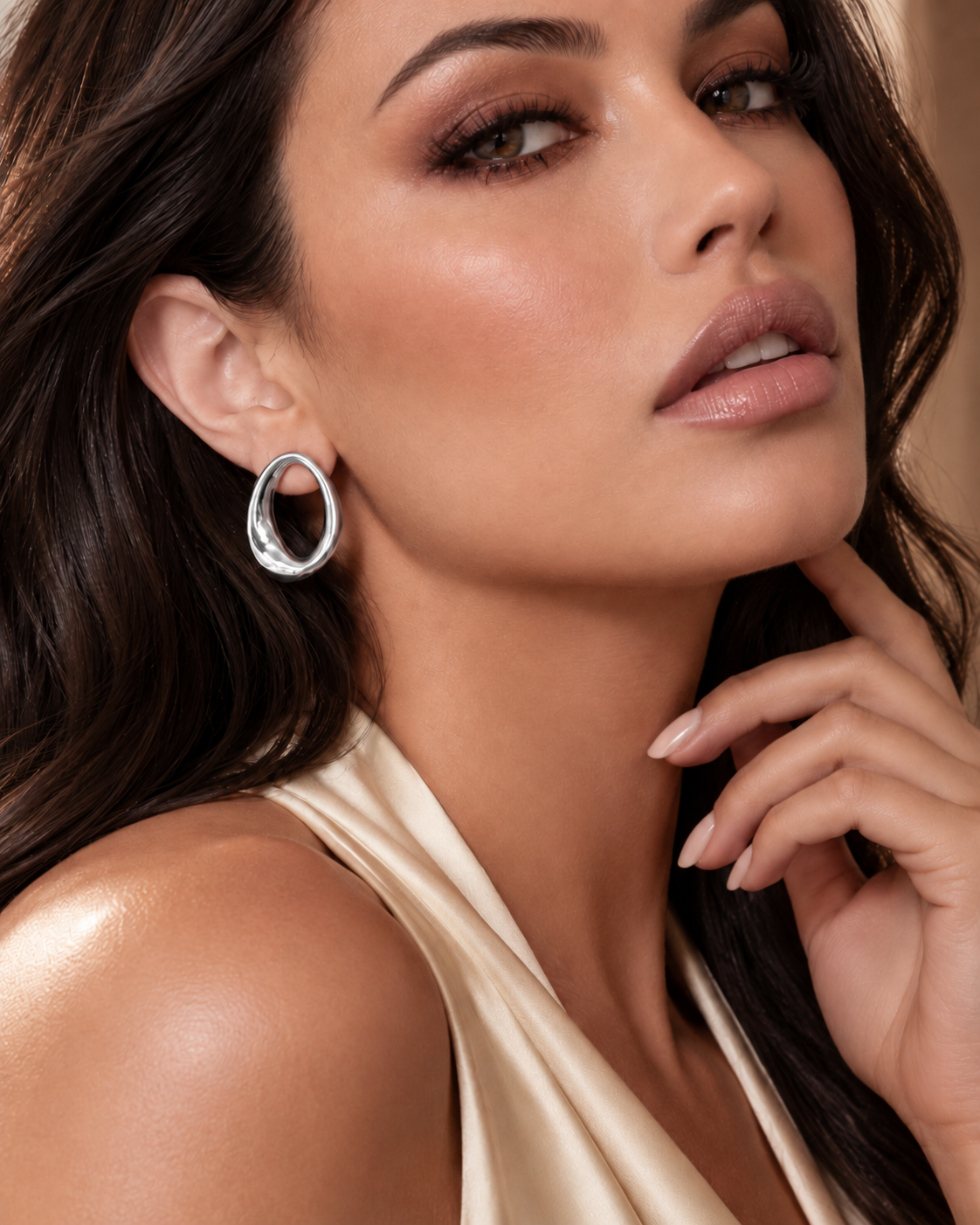 a model wearing an Open oval silver statement earrings 